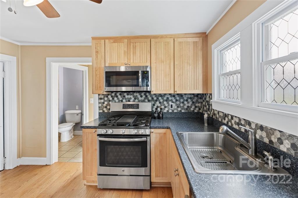 60 Shiloh Road Asheville, NC 28803 - Photo 6 of 13 a kitchen with a stove a sink and a microwave