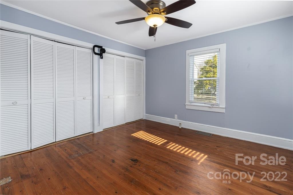 60 Shiloh Road Asheville, NC 28803 - Photo 7 of 13 a view of an empty room with a window and wooden floor