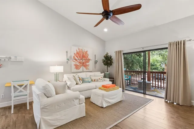 a bedroom with furniture and a large window