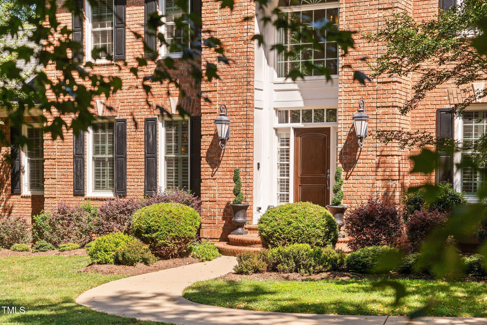 12012 Six Forks Road Raleigh, NC 27614 - Photo 4 of 100 a view of a house with brick walls and plants