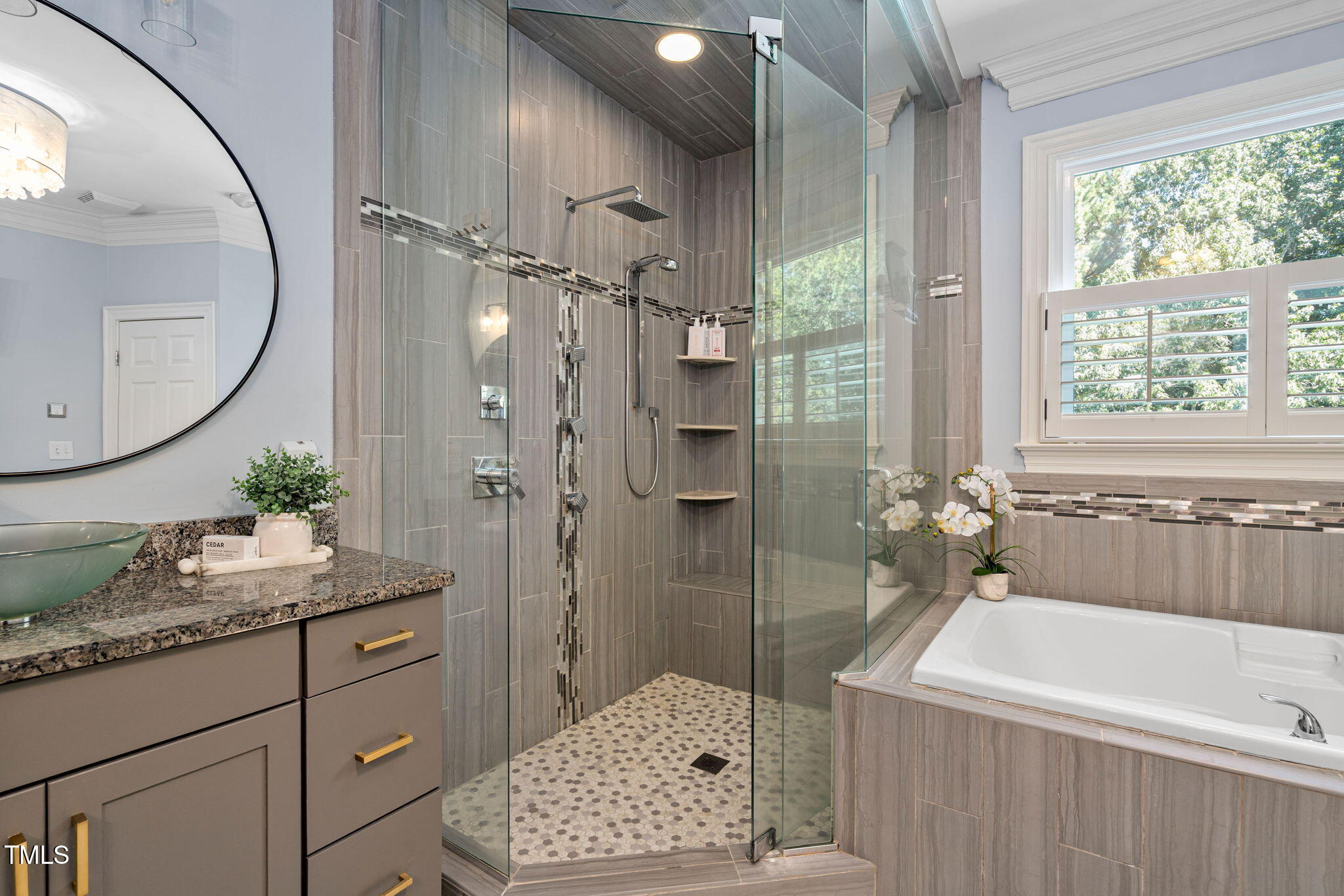12012 Six Forks Road Raleigh, NC 27614 - Photo 42 of 100 a bathroom with a granite countertop sink a mirror a vanity and a shower