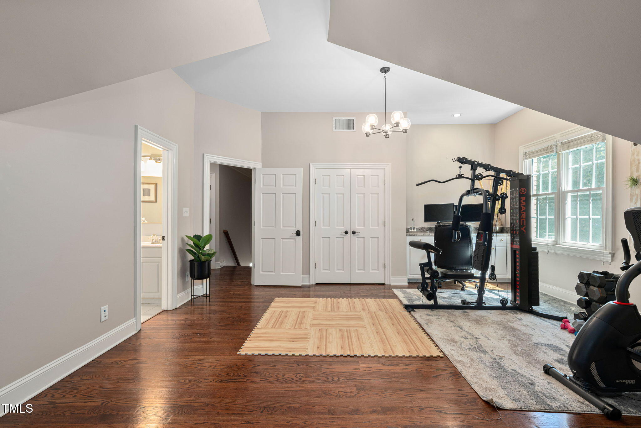 12012 Six Forks Road Raleigh, NC 27614 - Photo 53 of 100 a view of a room with gym equipment and floor to ceiling window