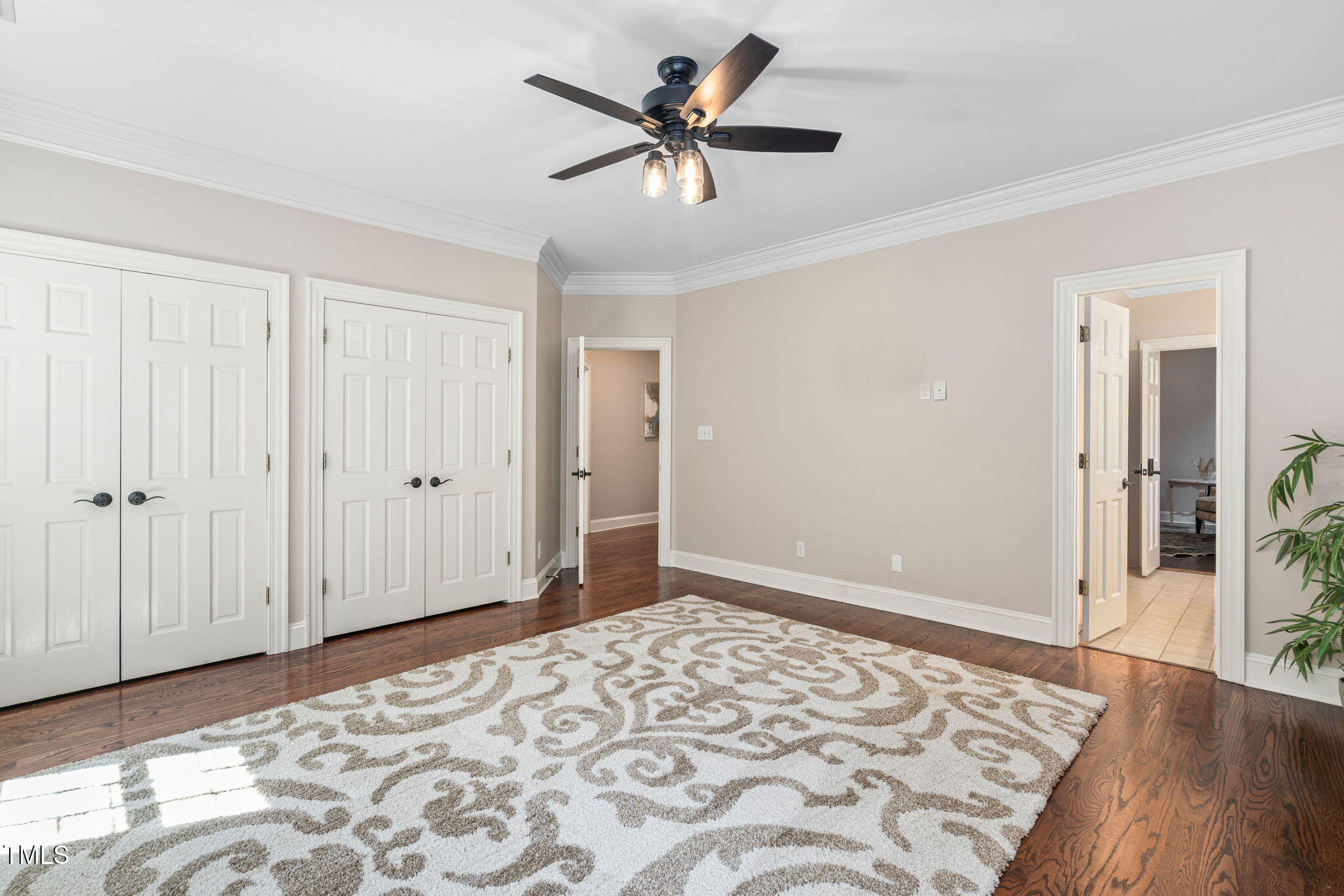 12012 Six Forks Road Raleigh, NC 27614 - Photo 57 of 100 a view of a livingroom with wooden floor and a ceiling fan