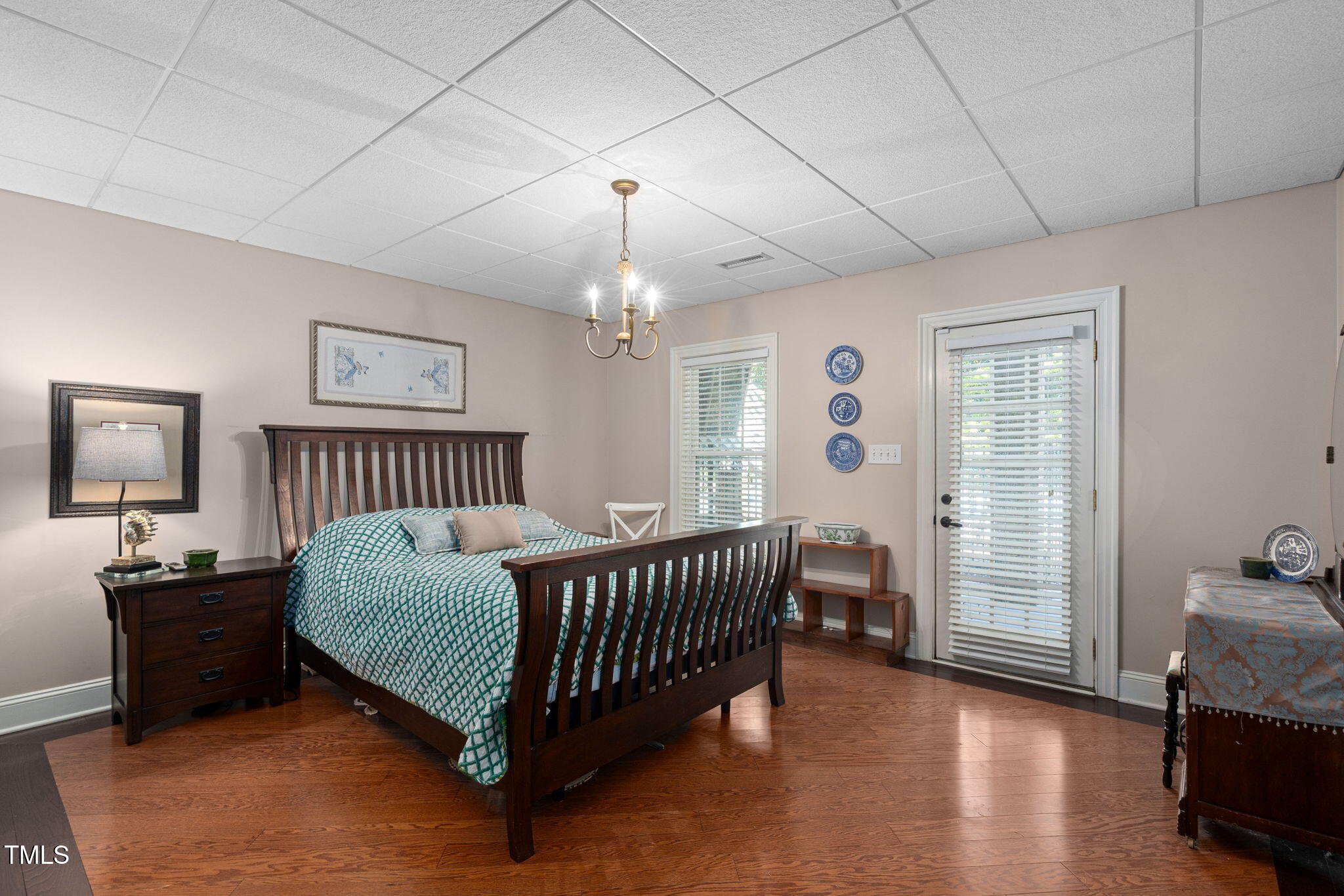 12012 Six Forks Road Raleigh, NC 27614 - Photo 70 of 100 a bedroom with a bed and wooden floor