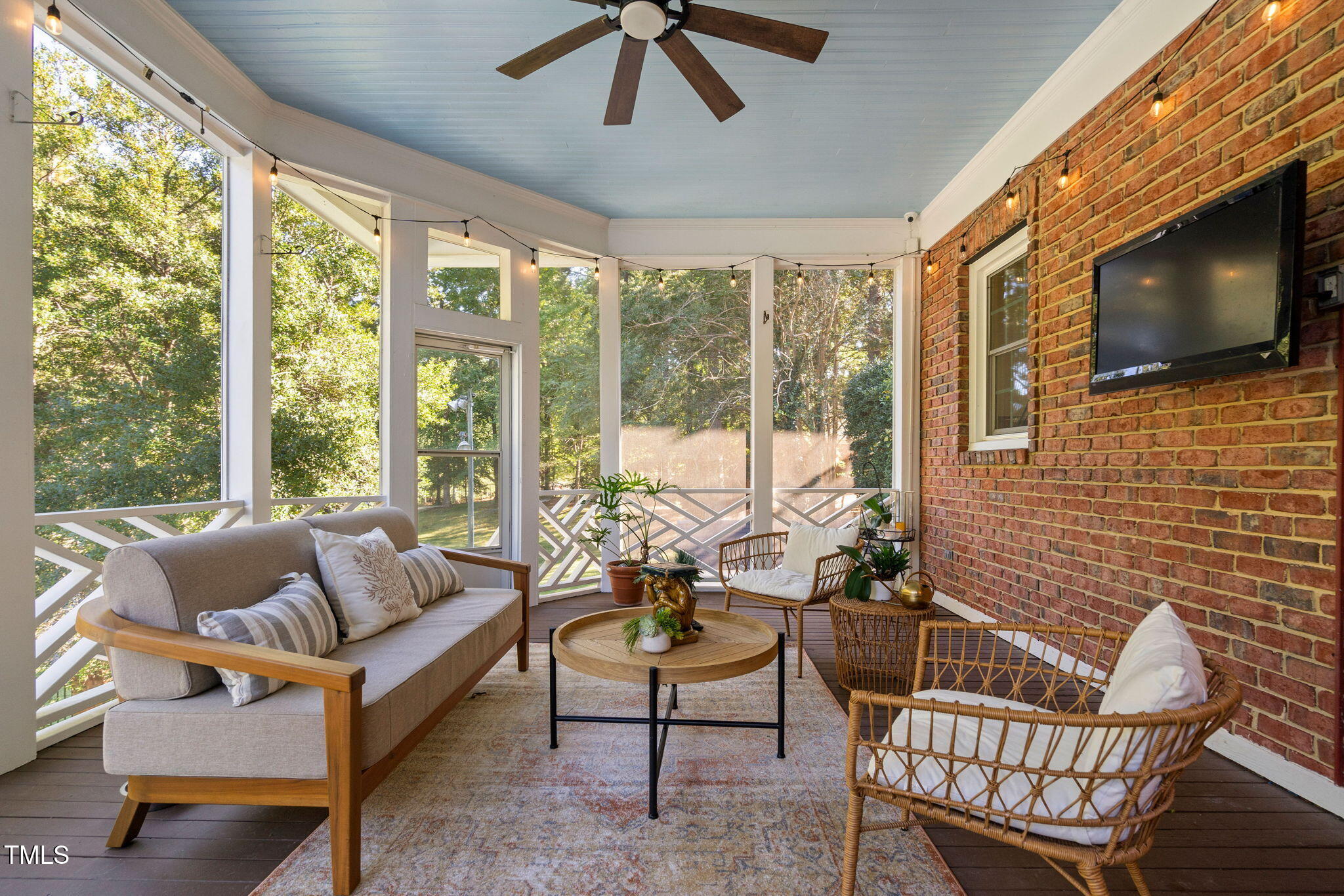 12012 Six Forks Road Raleigh, NC 27614 - Photo 79 of 100 a living room with furniture a flat screen tv and floor to ceiling windows