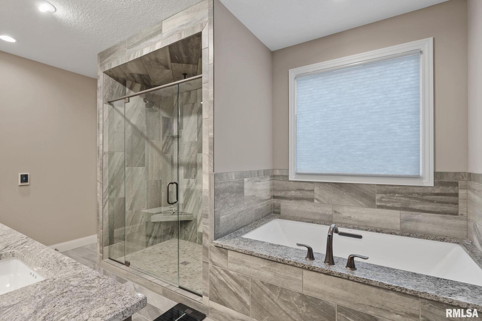 1422 Racine Court Davenport, IA 52804 - Photo 24 of 53 a bathroom with a granite countertop bathtub shower and sink