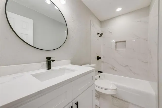 a bathroom with a sink a toilet and a mirror