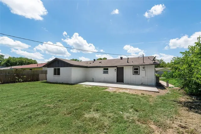 a house that has a big yard and large tree