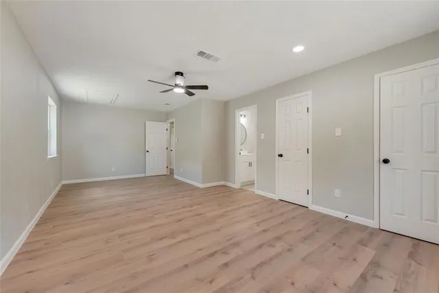 a view of an empty room with a ceiling fan