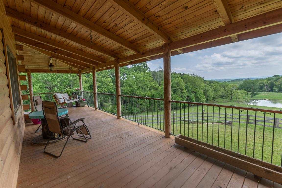 64 Rippetoe Lane Swoope, VA 24479 - Photo 6 of 48 a view of a balcony with chairs and wooden floor