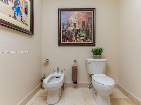 10700 Northwest 66th Street, Unit 508 Doral, FL 33178 - Photo 8 of 17 a white toilet sitting next to a bathroom sink