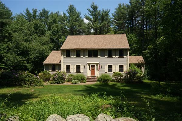 103 Taylor Road Stow, MA 01775 - Photo 1 of 15 a front view of a house with a garden
