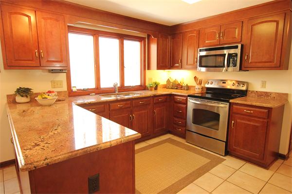 103 Taylor Road Stow, MA 01775 - Photo 4 of 15 a kitchen with stainless steel appliances granite countertop a stove a sink and a microwave