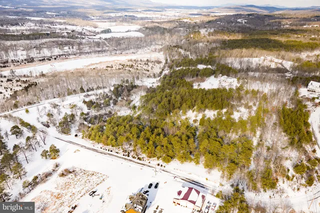 a view of side of snow with trees in the background