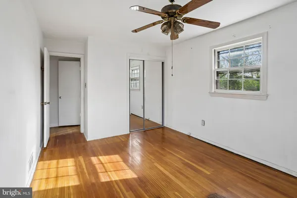 a view of an empty room and wooden floor
