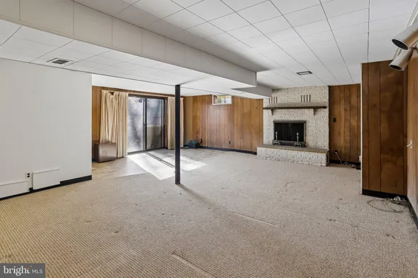 a view of an empty room with a fireplace