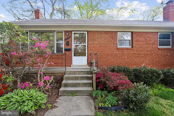 a front view of a house with flowers