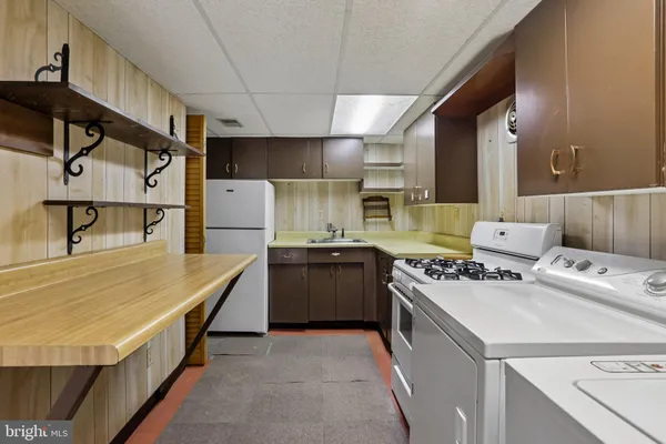a kitchen with a stove and a refrigerator