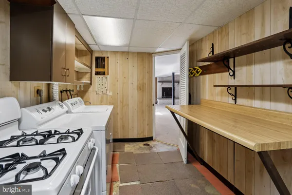 a kitchen with a sink a stove and a refrigerator