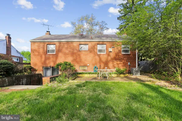 a view of a house with a backyard porch and sitting area