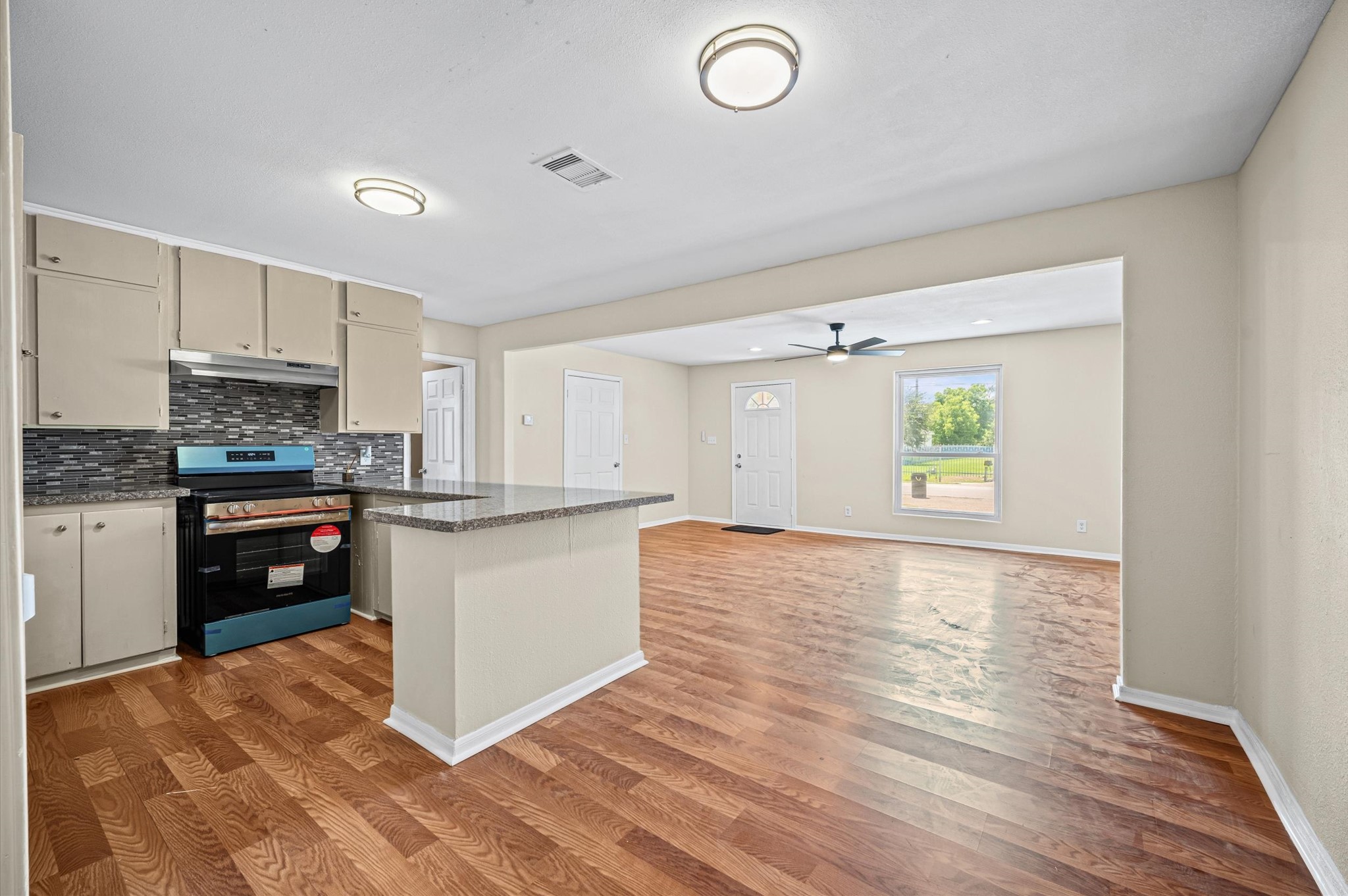 10621 Lane Street Houston, TX 77029 - Photo 11 of 29 a kitchen with a refrigerator and a stove top oven