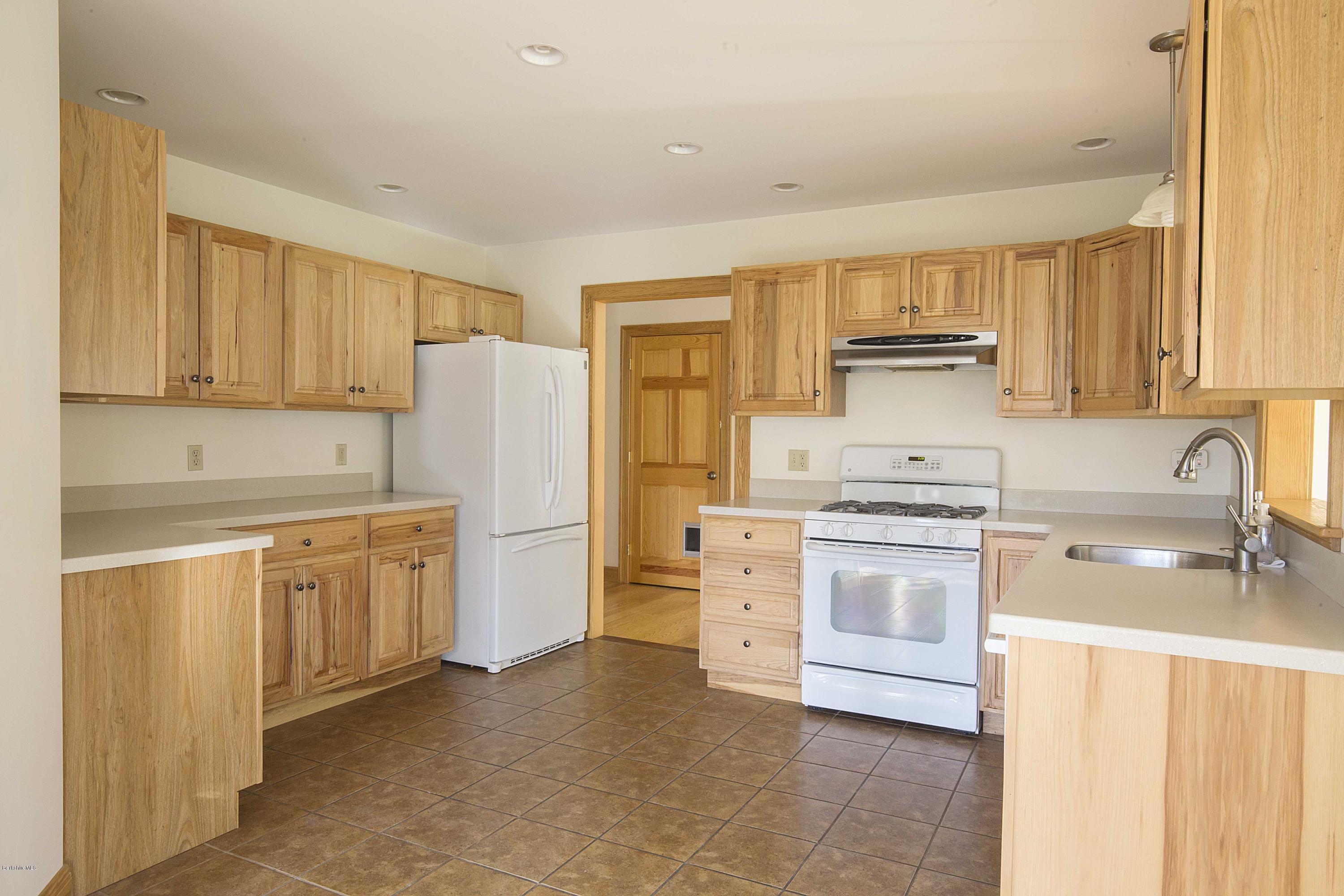 297 Cummington Road Ashfield, MA 01330 - Photo 3 of 27 a kitchen with a stove a sink and a refrigerator