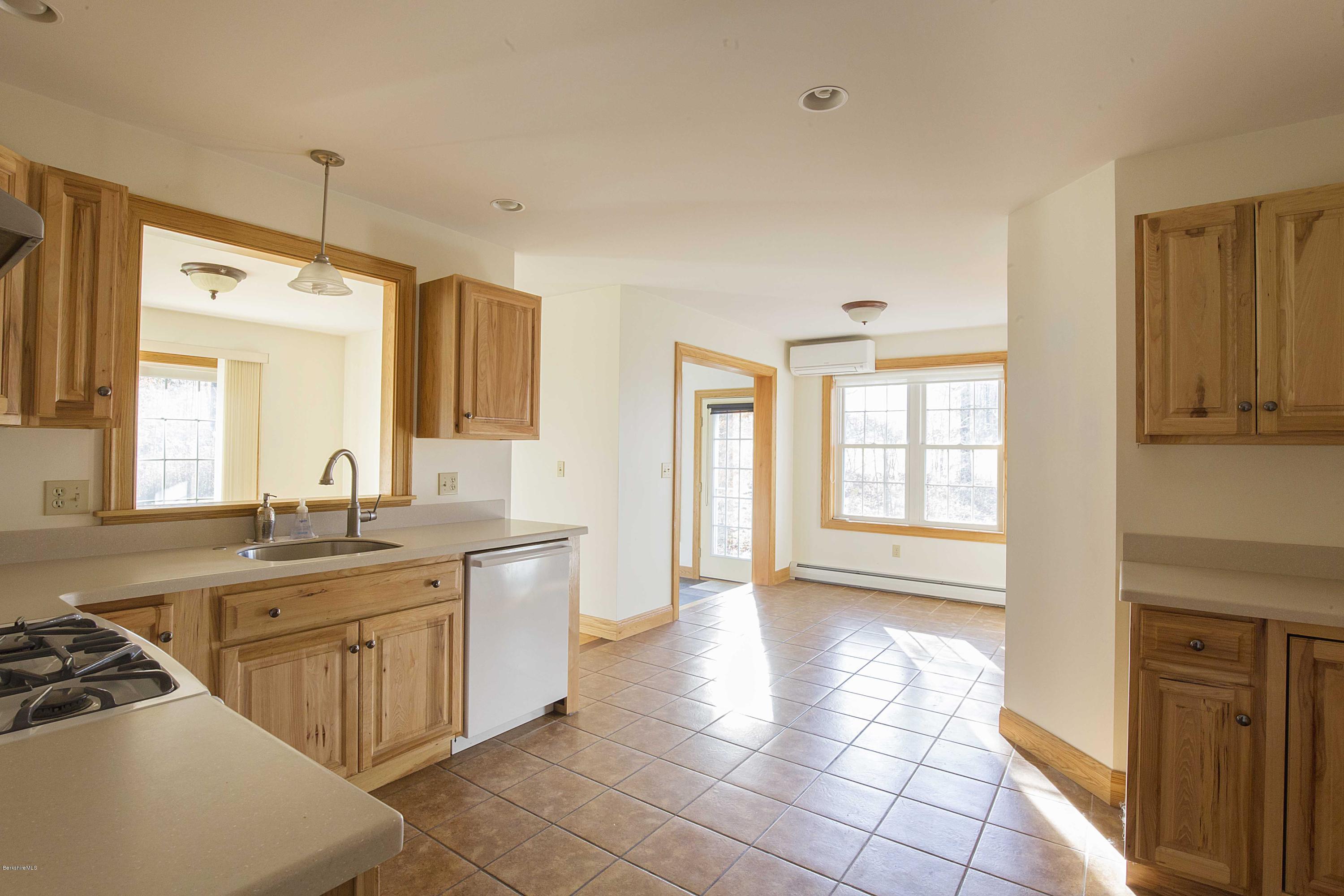297 Cummington Road Ashfield, MA 01330 - Photo 4 of 27 a spacious bathroom with a granite countertop sink a mirror and a bathtub