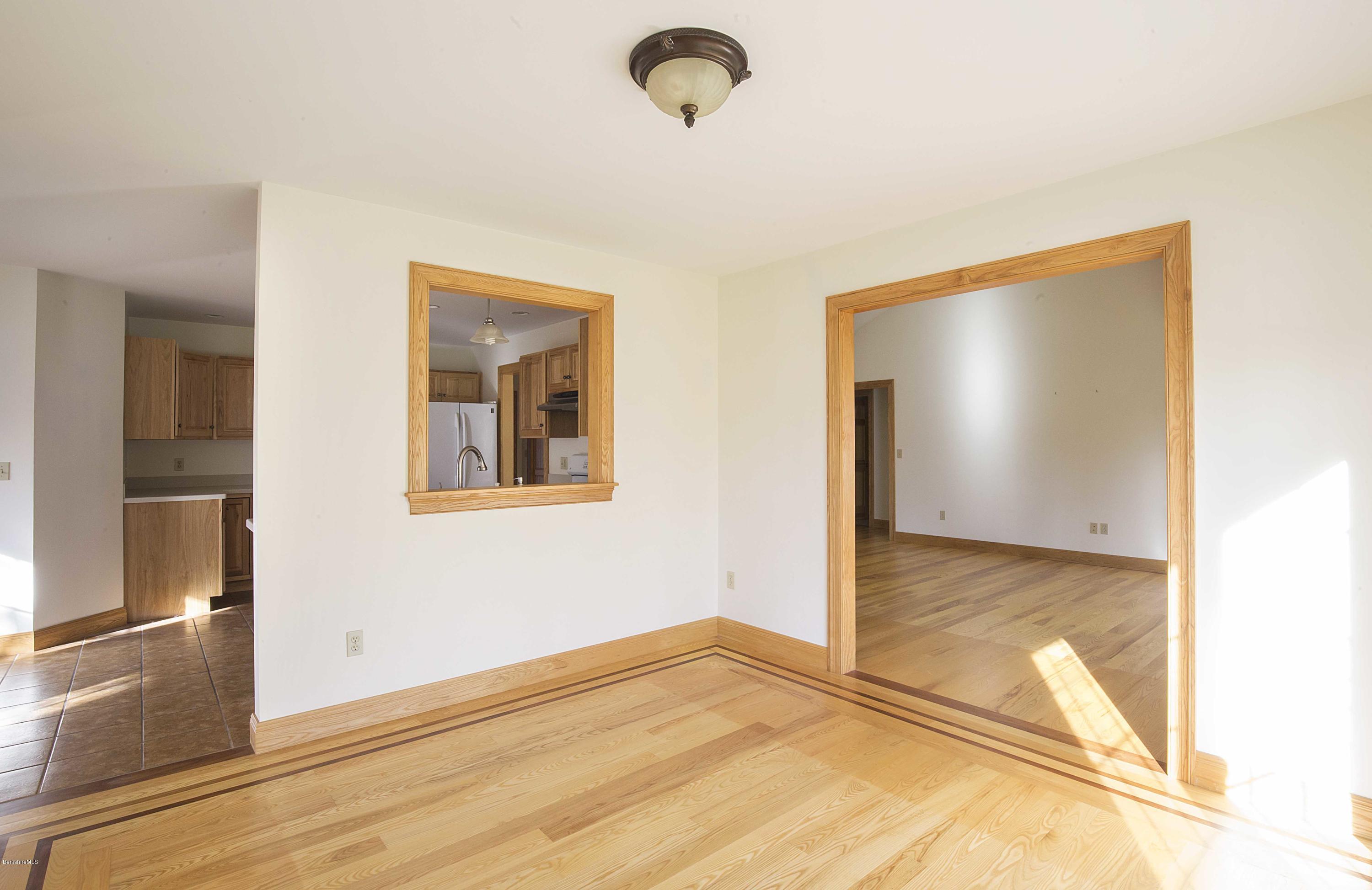 297 Cummington Road Ashfield, MA 01330 - Photo 5 of 27 a view of an empty room with window and wooden floor