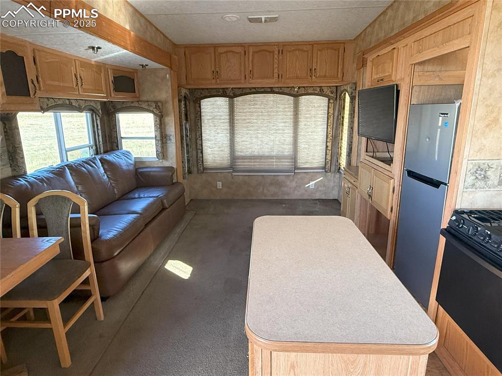 12325 Prairie Sun Point Colorado Springs, CO 80929 - Photo 11 of 15 a living room with furniture and a fireplace