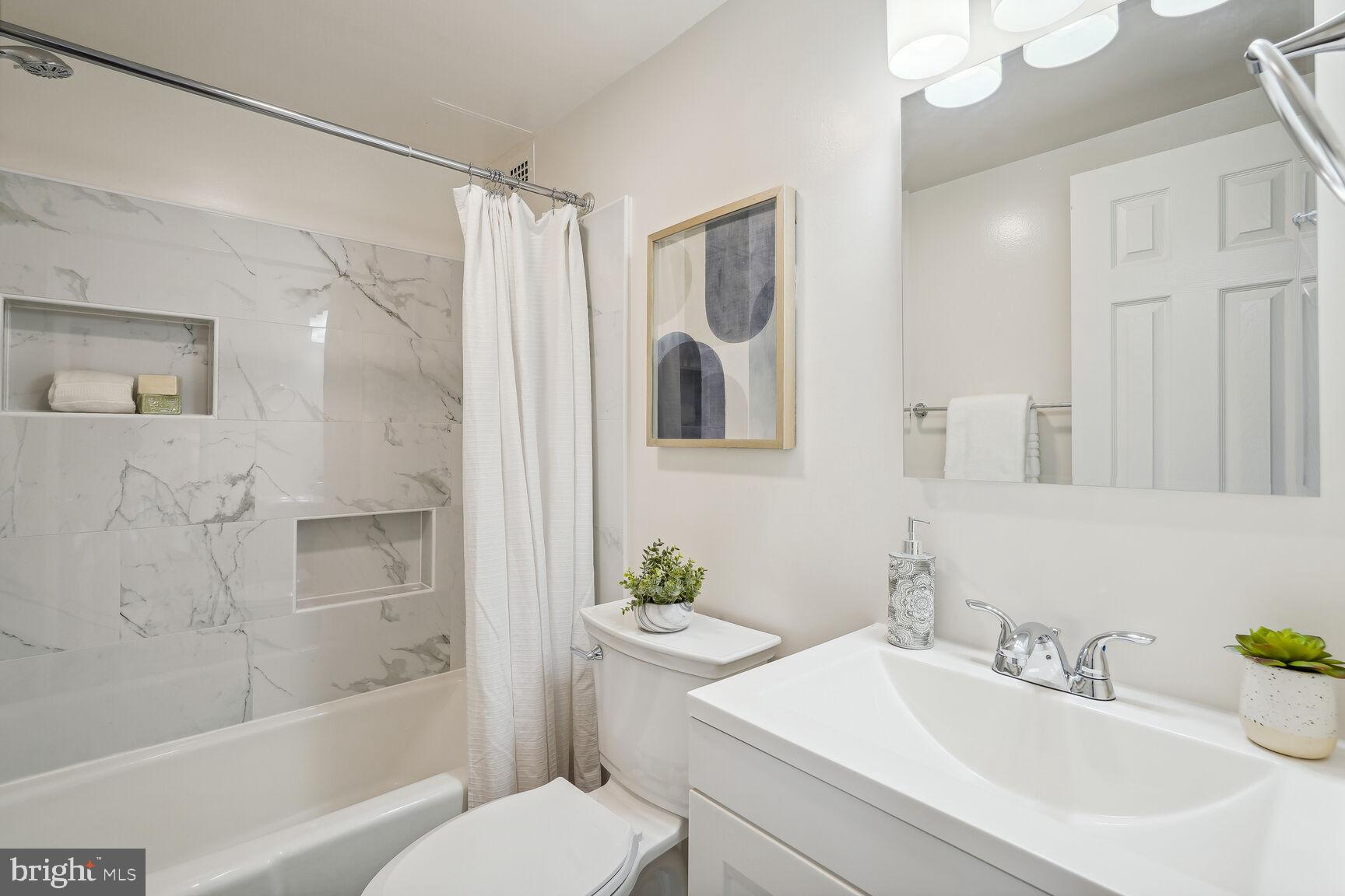 3245 Rio Drive, Unit 915 Falls Church, VA 22041 - Photo 15 of 31 a bathroom with a sink toilet and shower