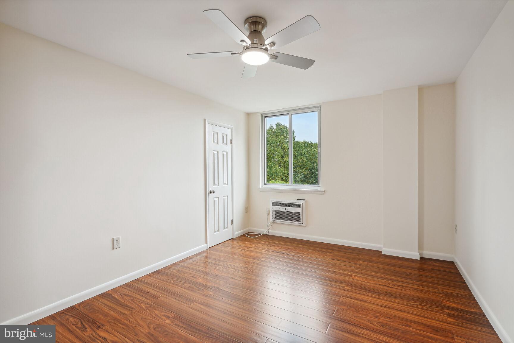3245 Rio Drive, Unit 915 Falls Church, VA 22041 - Photo 18 of 31 an empty room with wooden floor and windows