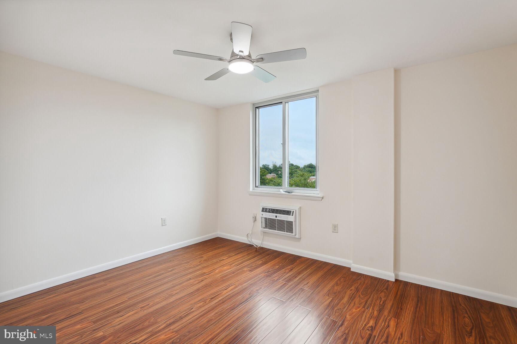 3245 Rio Drive, Unit 915 Falls Church, VA 22041 - Photo 20 of 31 an empty room with wooden floor and windows