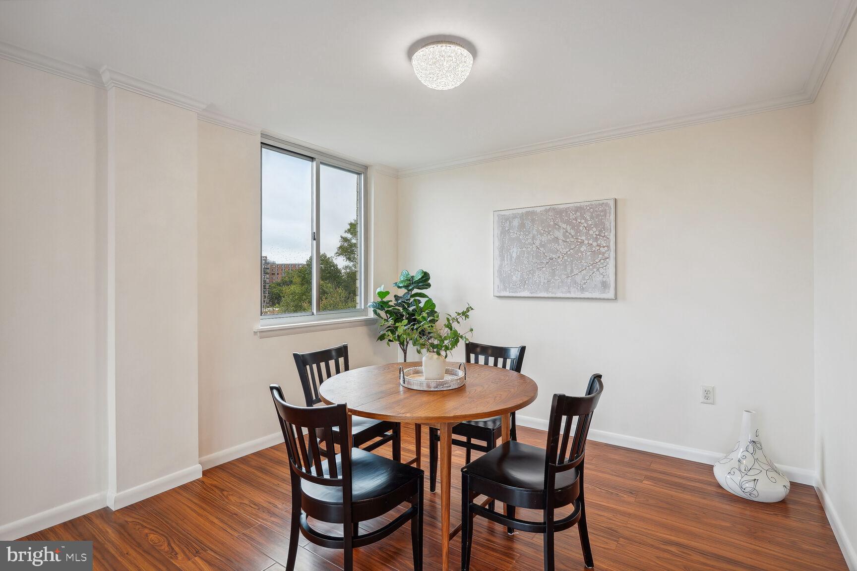 3245 Rio Drive, Unit 915 Falls Church, VA 22041 - Photo 5 of 31 a view of a dining room with furniture window and wooden floor