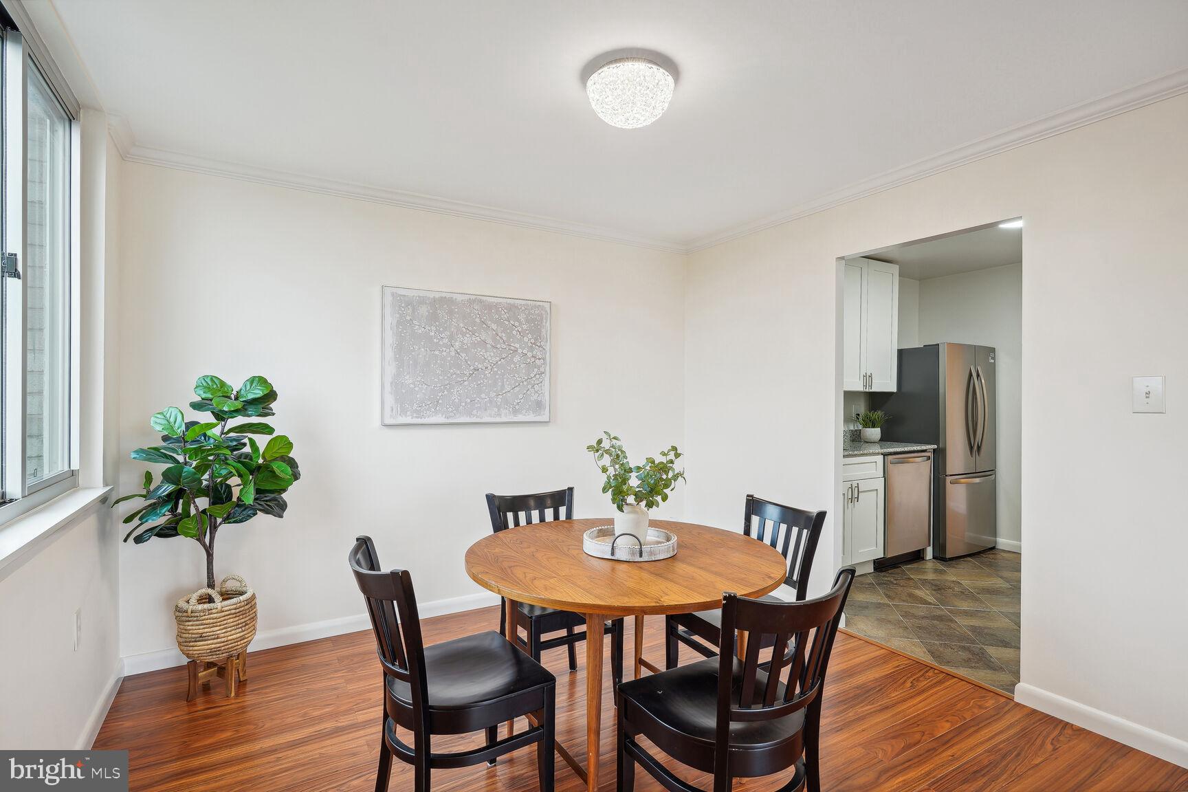 3245 Rio Drive, Unit 915 Falls Church, VA 22041 - Photo 6 of 31 a view of a dining room with furniture and wooden floor