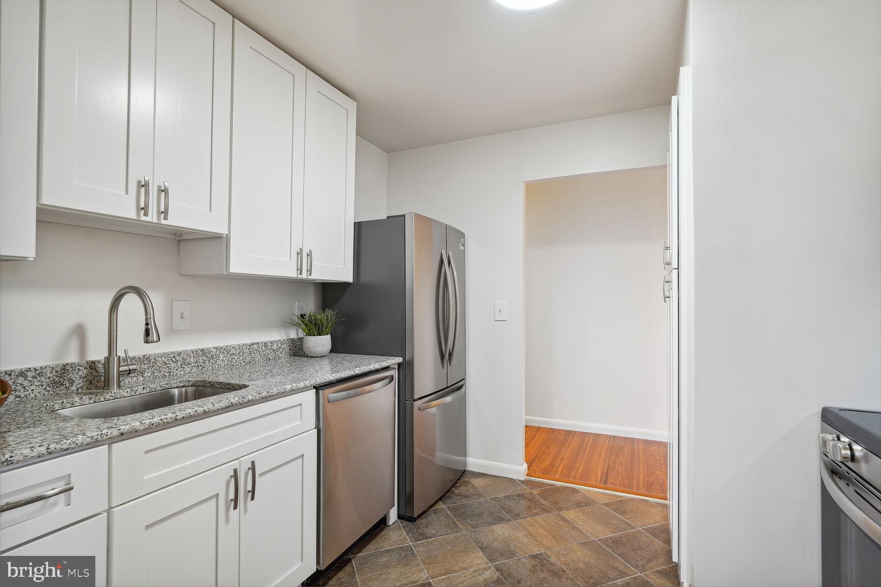 3245 Rio Drive, Unit 915 Falls Church, VA 22041 - Photo 7 of 31 a kitchen with stainless steel appliances granite countertop a refrigerator and a sink