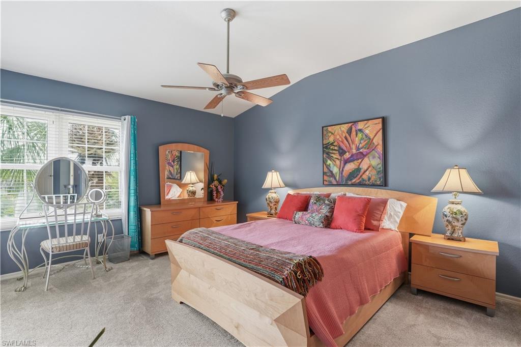 10871 Crooked River Road, Unit 202 Estero, FL 34135 - Photo 23 of 46 a bedroom with a bed and a couch