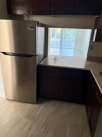 a kitchen with a refrigerator and window