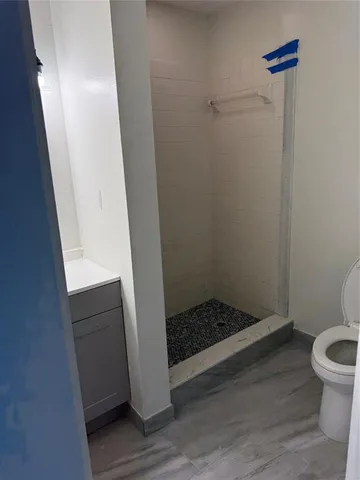a bathroom with a shower and toilet
