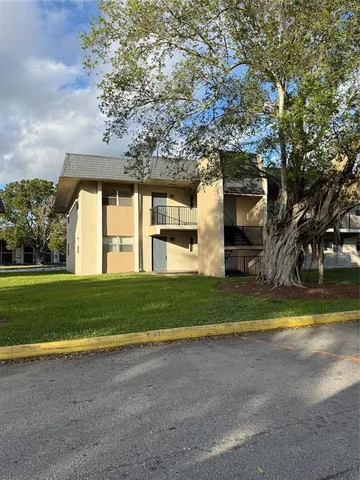 a front view of a house with a yard and a big yard