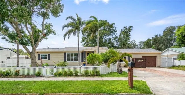 a front view of a house with a garden and plants