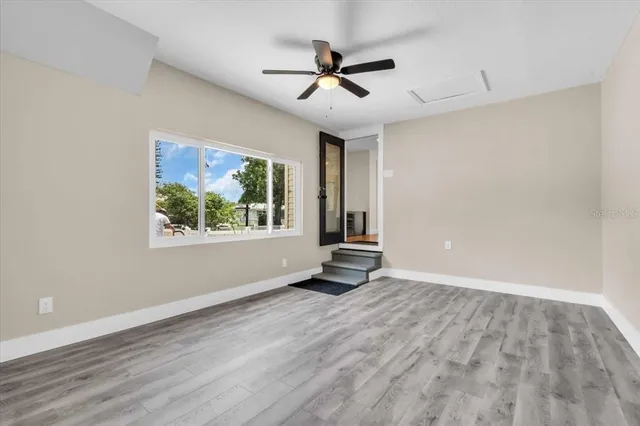 wooden floor in an empty room with a window