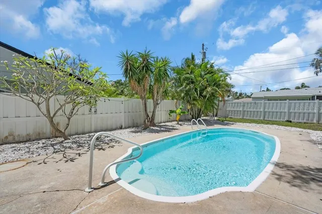 a view of a swimming pool with a lounge chair