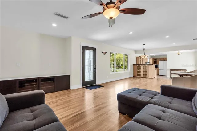 a living room with furniture and a wooden floor