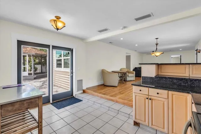 a spacious bathroom with a granite countertop sink and a large mirror