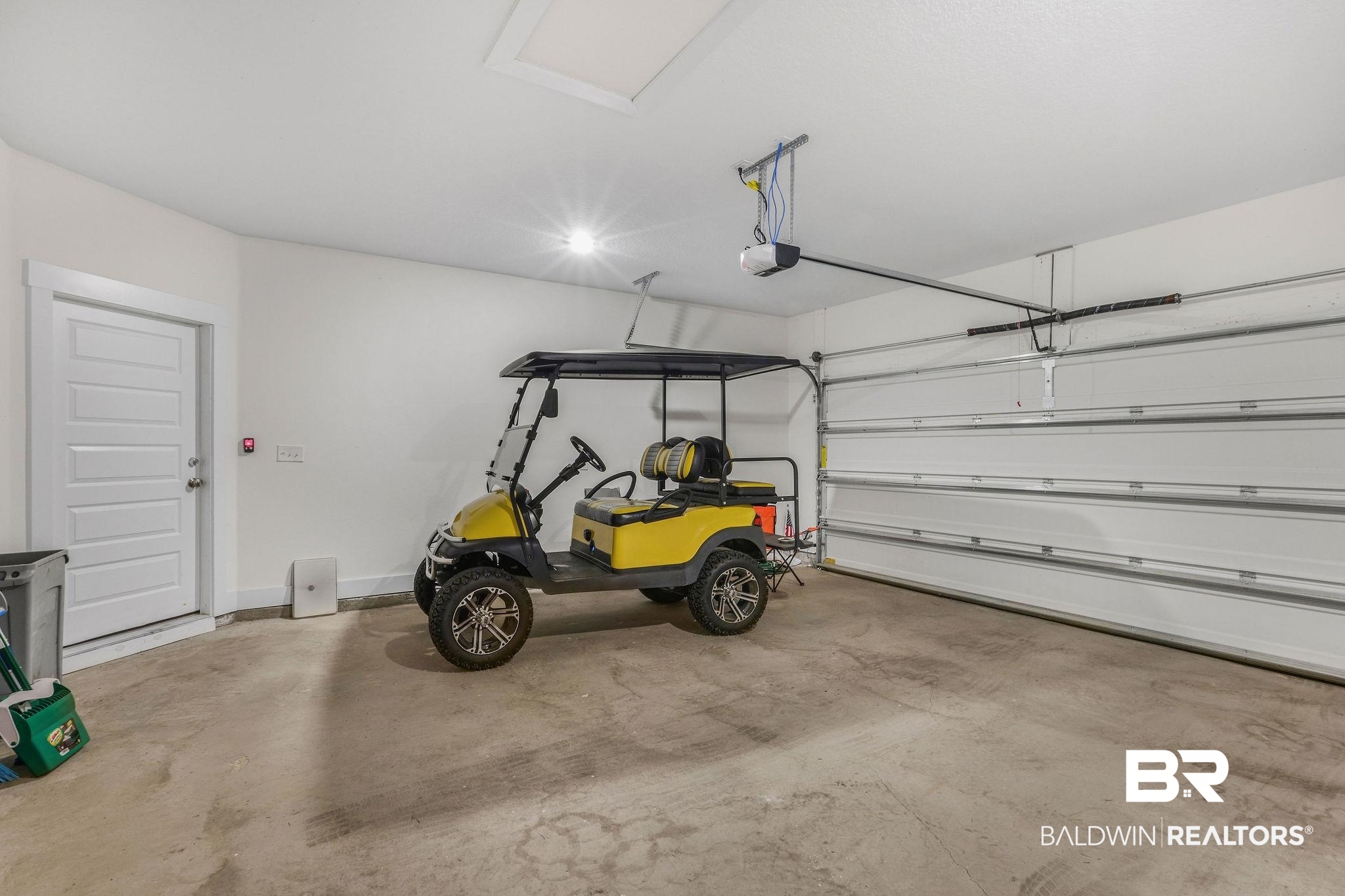 9859 Willet Way Foley, AL 36535 - Photo 21 of 23 Garage with baseboards and a garage door opener
