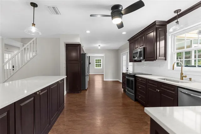 a view of a kitchen with a sink and dishwasher wooden floor