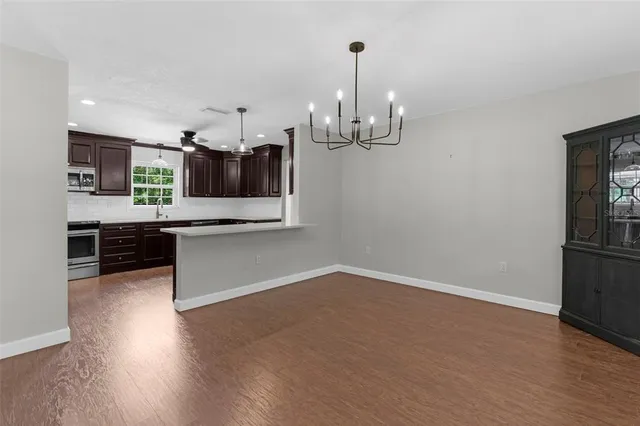 an empty room with a window and ceiling fan