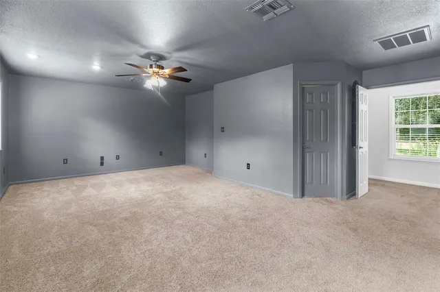 a view of a lake with a house in a yard