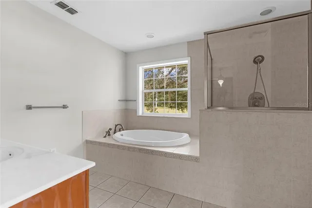 an aerial view of a house with a yard swimming pool and outdoor seating