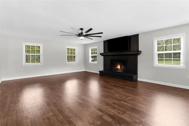 a kitchen with stainless steel appliances granite countertop a refrigerator a sink and wooden cabinets